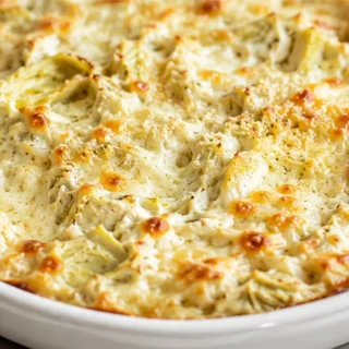 OMG! The Ultimate Hot Artichoke Dip You NEED! Artichoke dip: bake this incredibly creamy and hot appetizer. Perfect for parties, it's packed with artichoke hear