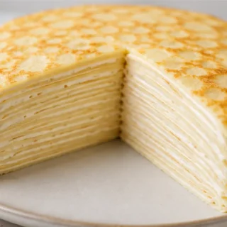 Mille Crêpe Cake: Layers of Pure Bliss! - mille crepe - Mille Crêpe Cake: layer delicate, paper-thin crêpes with rich vanilla whipped cream. Master this elegant