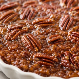 Magic Crustless Pecan Pie Recipe! Crustless pecan pie: bake this simple, sweet, and nutty dessert. Perfect for holidays and naturally gluten-free, a delicious t